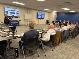 Photo showing guests attending a presentation during the RevSpring CAC Meeting
