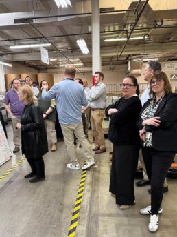 Photo at RevSpring showing guests at RevSpring CAC Meeting Factory-Tour