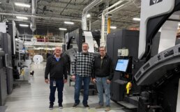 Photo: Mail-Gard Team at their Facility in front of a HP printer